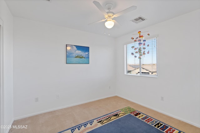 unfurnished room with carpet and ceiling fan