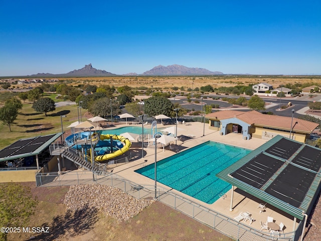 view of swimming pool with a mountain view