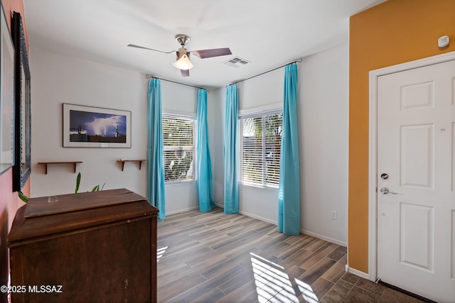 foyer with hardwood / wood-style floors and ceiling fan