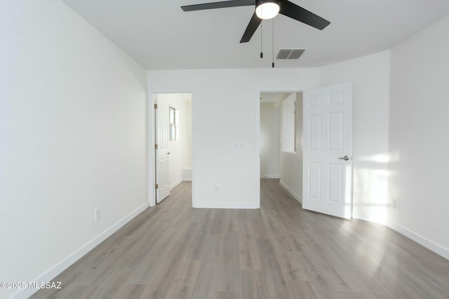 unfurnished bedroom with visible vents, baseboards, ceiling fan, and light wood finished floors