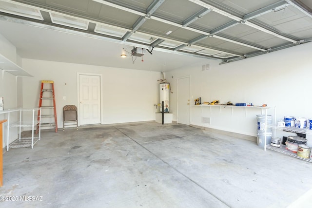 garage with a garage door opener and water heater