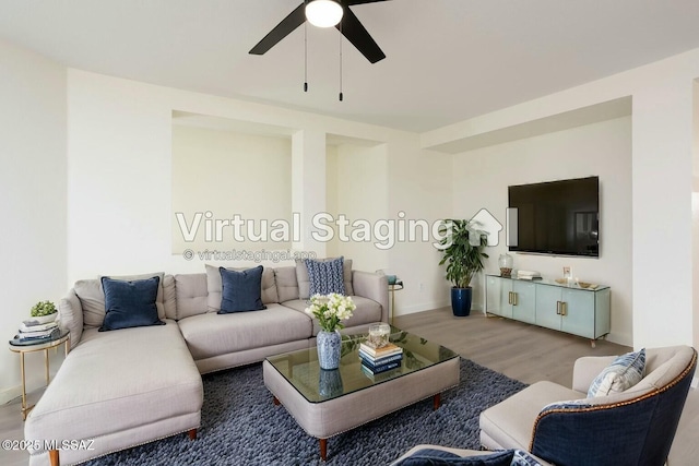 living room with wood-type flooring and ceiling fan