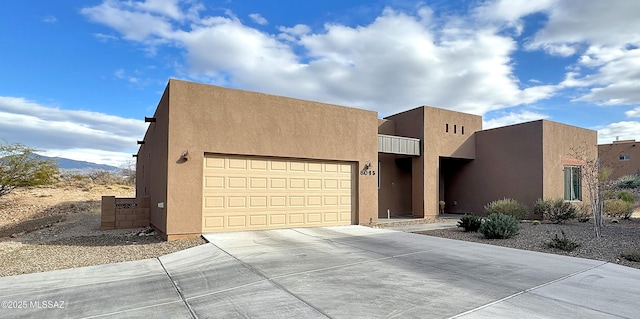 southwest-style home with a garage and a mountain view