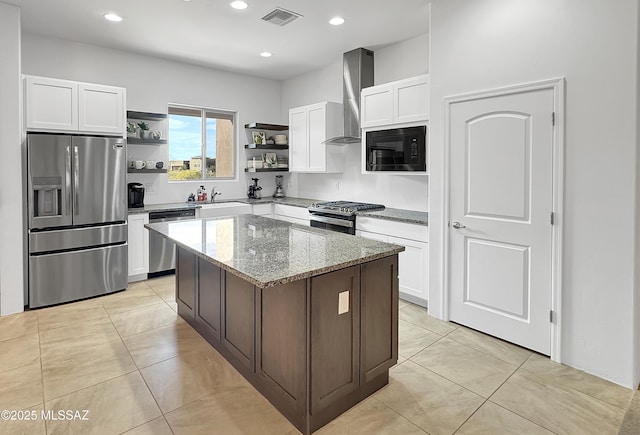8015 S Galileo Ln, Tucson, AZ 85747 - kitchen with light stone counters, open shelves, visible vents, wall chimney exhaust hood, and appliances with stainless steel finishes