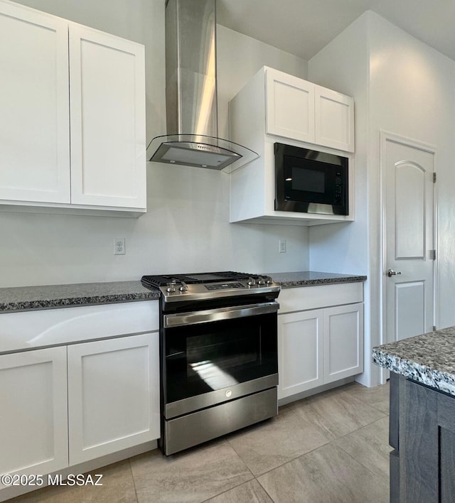 8015 S Galileo Ln, Tucson, AZ 85747 - kitchen with stainless steel range with gas cooktop, wall chimney exhaust hood, black microwave, and white cabinets