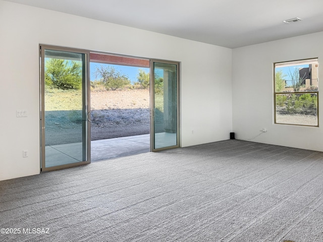 8015 S Galileo Ln, Tucson, AZ 85747 - carpeted spare room featuring a healthy amount of sunlight and visible vents