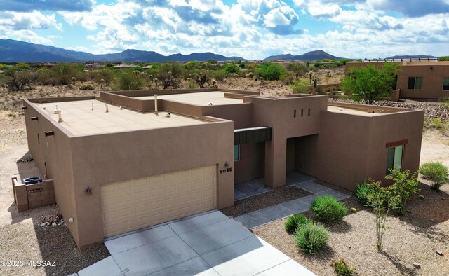 8015 S Galileo Ln, Tucson, AZ 85747 - pueblo revival-style home featuring a garage, stucco siding, and a mountain view