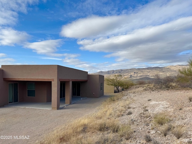 8015 S Galileo Ln, Tucson, AZ 85747 - rear view of house with a patio, stucco siding, and a mountain view