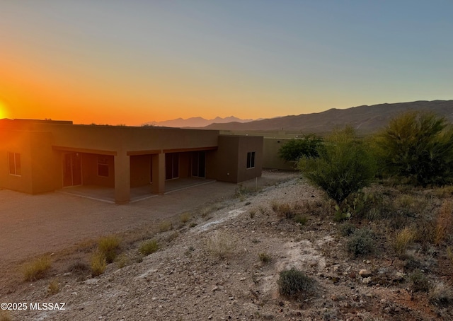 exterior space featuring a mountain view and a patio area