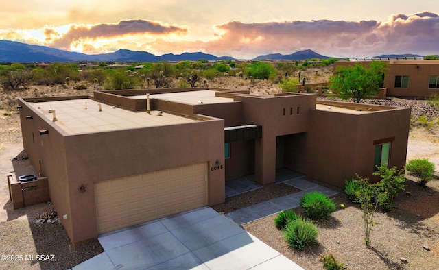 8015 S Galileo Ln, Tucson, AZ 85747 - southwest-style home featuring a garage, a mountain view, and stucco siding