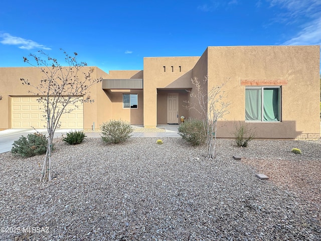 8015 S Galileo Ln, Tucson, AZ 85747 - pueblo-style home featuring a garage and stucco siding