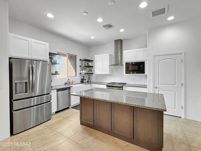 8015 S Galileo Ln, Tucson, AZ 85747 - kitchen featuring open shelves, wall chimney exhaust hood, stainless steel appliances, and visible vents