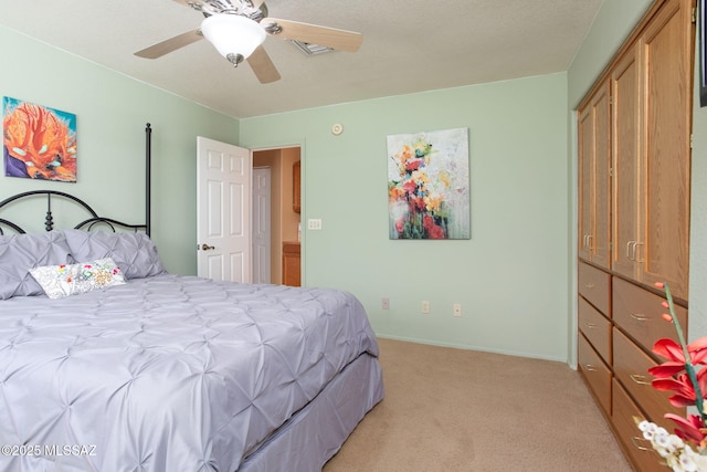 bedroom featuring ceiling fan, a closet, and light colored carpet