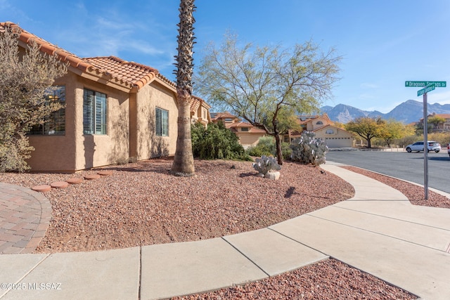 view of property exterior with a mountain view