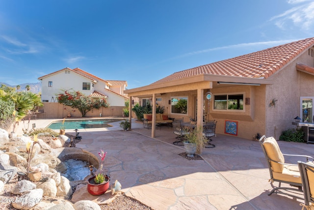 view of patio / terrace with a fenced in pool and an outdoor hangout area