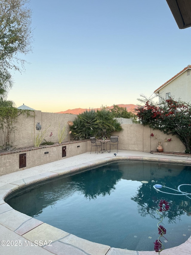 view of pool at dusk