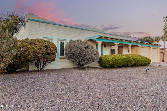 view of front of property featuring covered porch and a garage