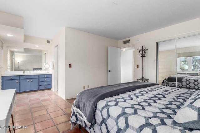 tiled bedroom with sink and a closet