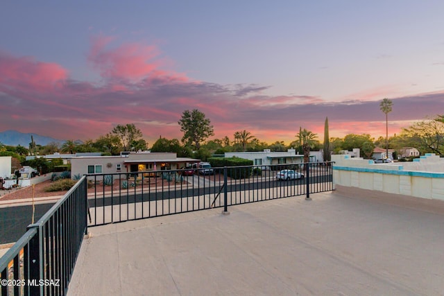 pool at dusk featuring a mountain view