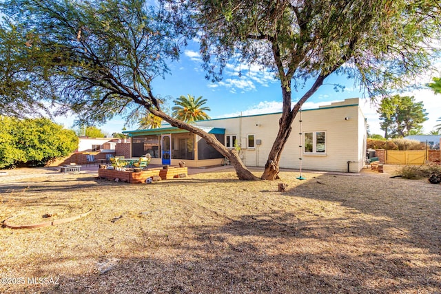 rear view of property featuring a sunroom