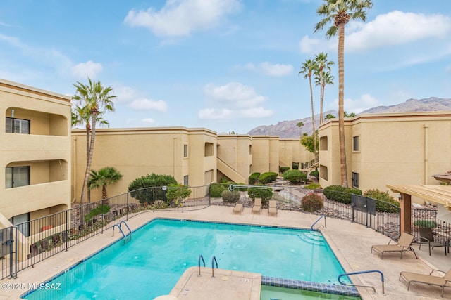 view of swimming pool featuring a mountain view and a patio area