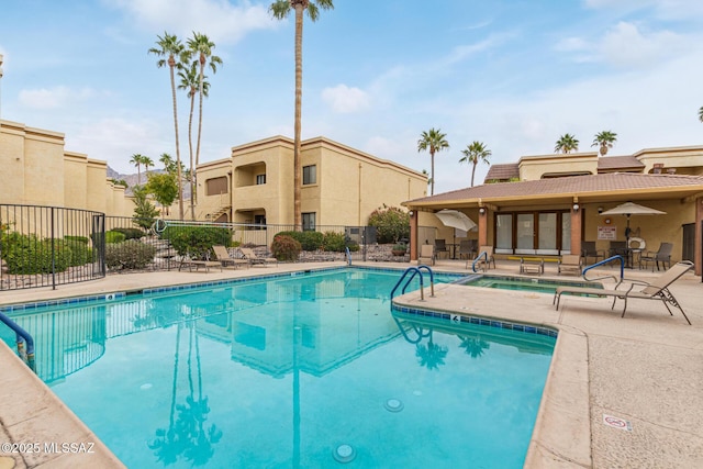 view of pool featuring a patio area and a community hot tub