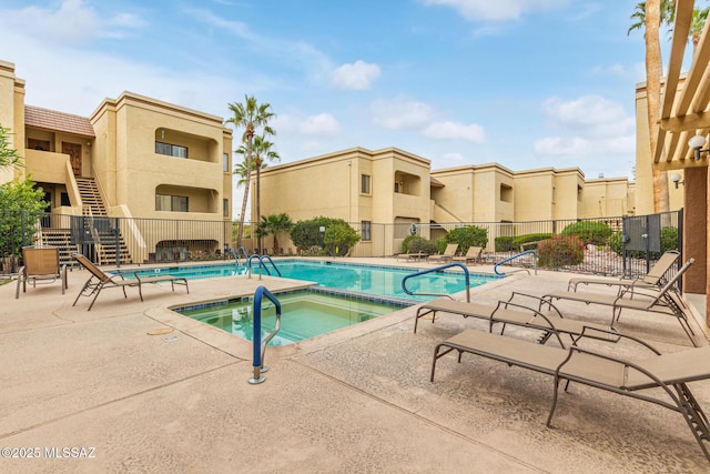 view of pool featuring a community hot tub and a patio