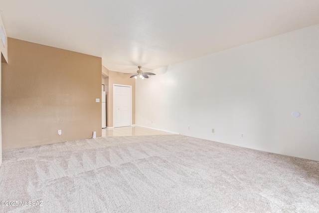 carpeted empty room featuring ceiling fan