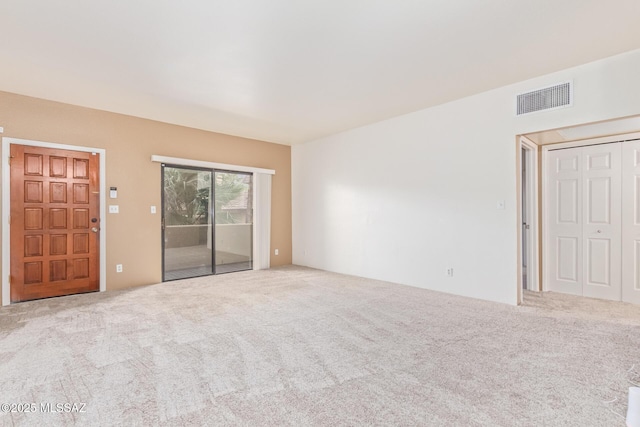 unfurnished living room featuring carpet