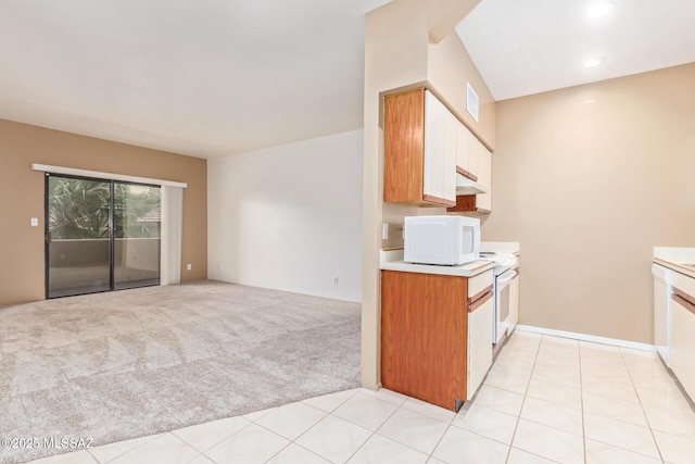 kitchen with light carpet, white appliances, and white cabinetry