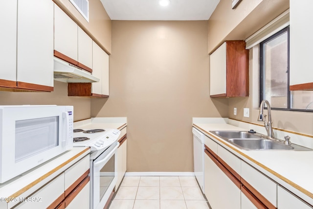 kitchen with white cabinets, white appliances, sink, and light tile patterned floors