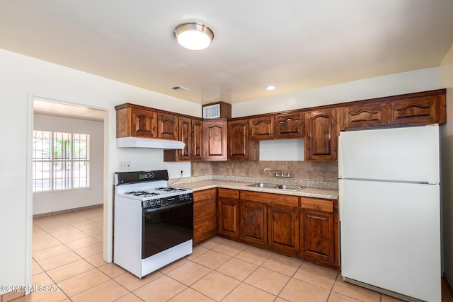 858 W Calle Evelina, Tucson, AZ 85706 - kitchen featuring decorative backsplash, white appliances, sink, and light tile patterned floors