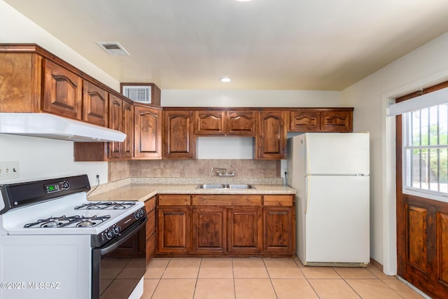858 W Calle Evelina, Tucson, AZ 85706 - kitchen with light tile patterned flooring, white appliances, sink, and tasteful backsplash