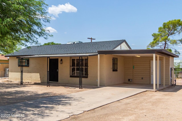 ranch-style house featuring a carport