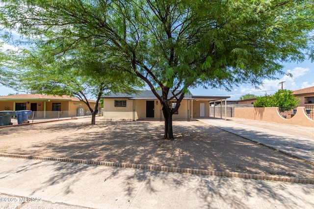 ranch-style house featuring a carport