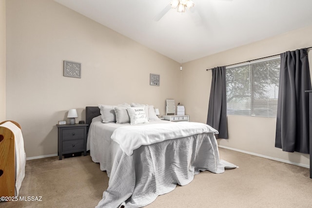 bedroom featuring ceiling fan, light colored carpet, and vaulted ceiling