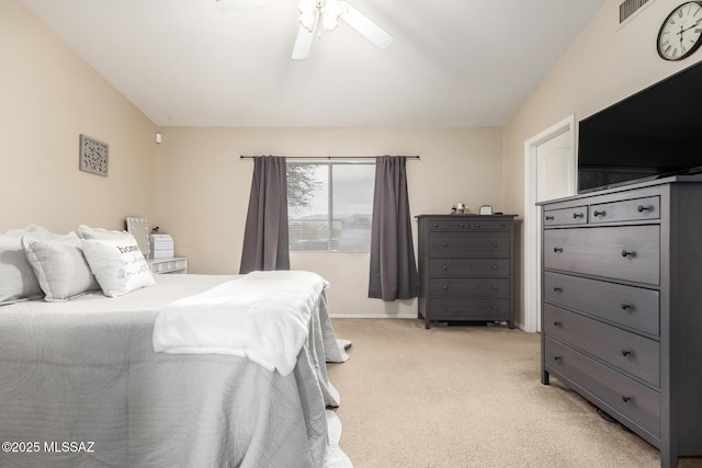 bedroom featuring light carpet, vaulted ceiling, and ceiling fan