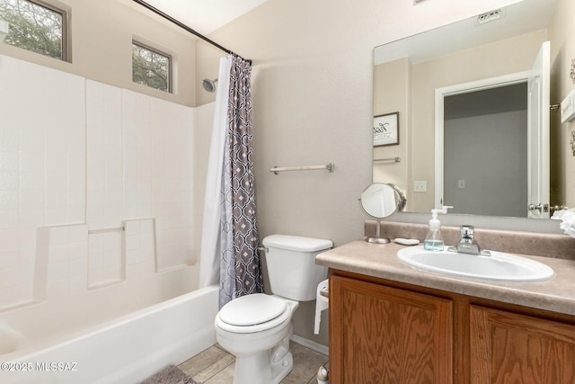 full bathroom featuring tile patterned flooring, shower / bath combination with curtain, toilet, and vanity