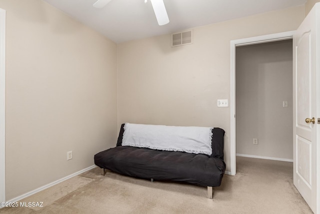 living area with ceiling fan and carpet floors