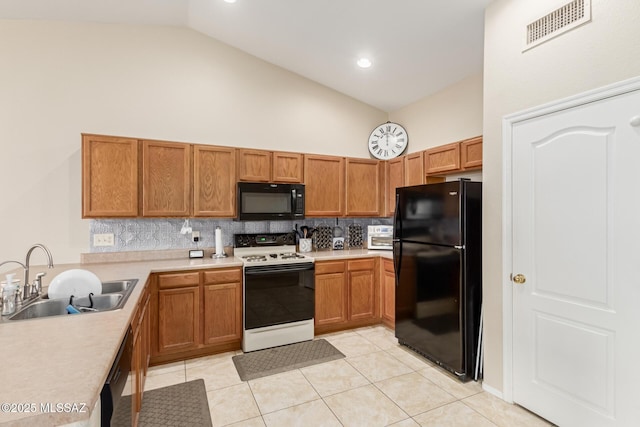 kitchen with backsplash, high vaulted ceiling, black appliances, sink, and light tile patterned floors