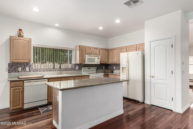 kitchen with light brown cabinetry, dark hardwood / wood-style flooring, white appliances, sink, and a center island