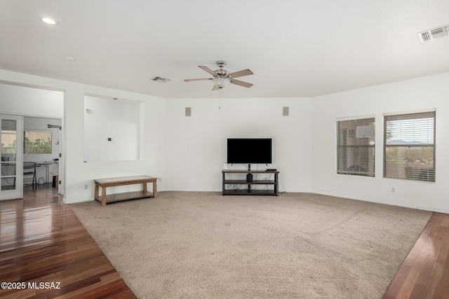 living room with ceiling fan and dark wood-type flooring