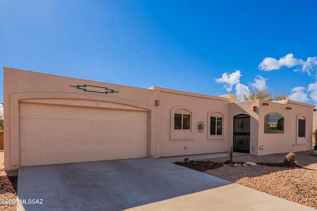 pueblo-style home with a garage