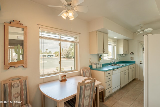 kitchen featuring sink, light tile patterned floors, white appliances, and ceiling fan