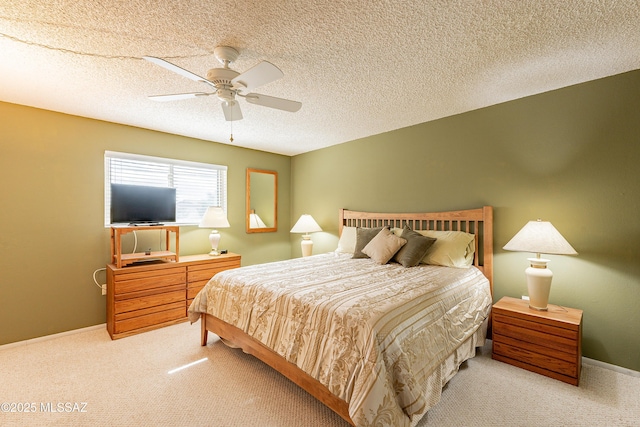 bedroom featuring a textured ceiling, ceiling fan, and carpet