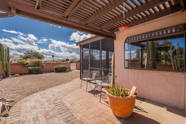 view of patio with a sunroom and a pergola