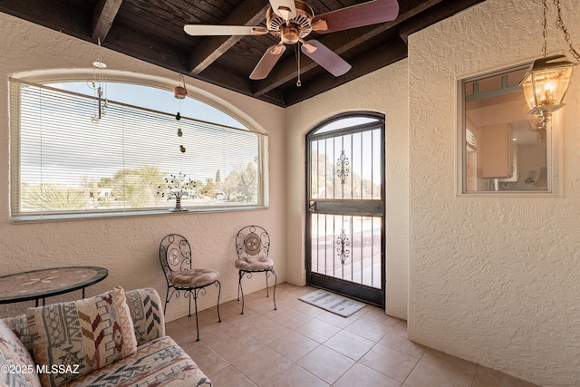 sitting room featuring light tile patterned flooring, vaulted ceiling with beams, a wealth of natural light, and wooden ceiling