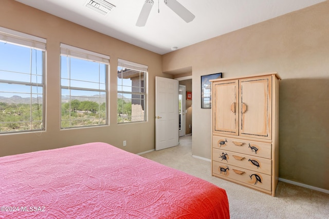 bedroom with ceiling fan and light carpet