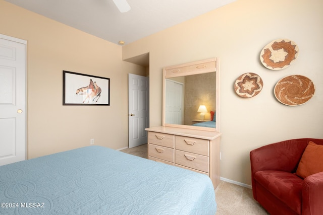 bedroom featuring light carpet and ceiling fan