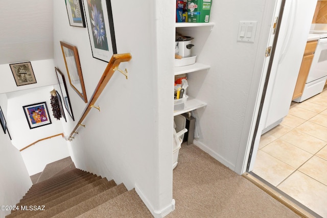 stairs featuring carpet flooring